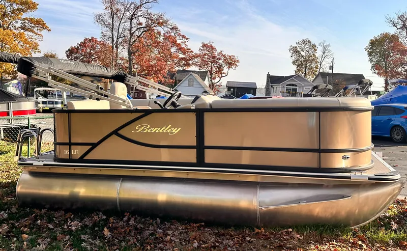 Slide: The Image of 2025 Bentley Pontoons LE 160CR pontoon boat in a scenic outdoor setting. - 2