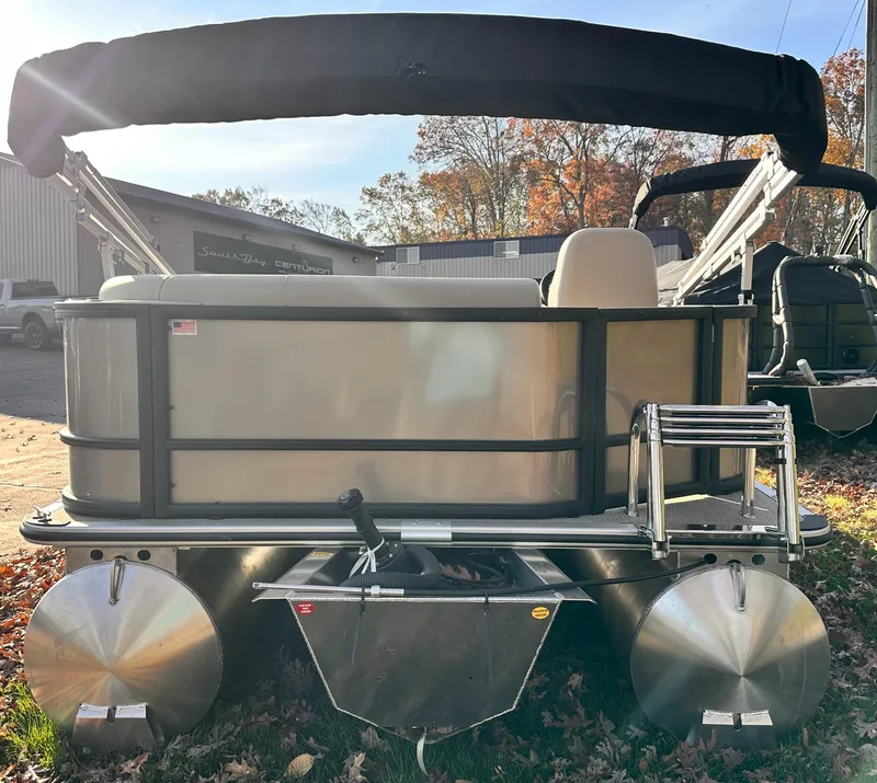 Slide: The Image of 2025 Bentley Pontoons LE 160CR pontoon boat with canopy, parked outdoors. - 5