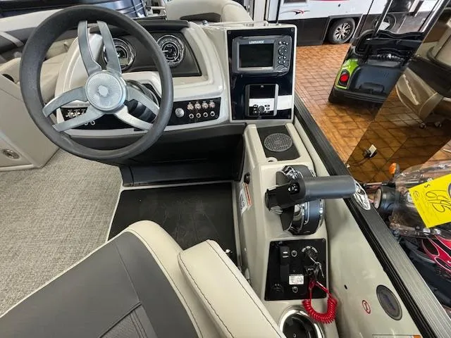 Slide: The Image of 2025 Barletta Cabrio 22 QC boat dashboard with steering wheel and control panel. - 10