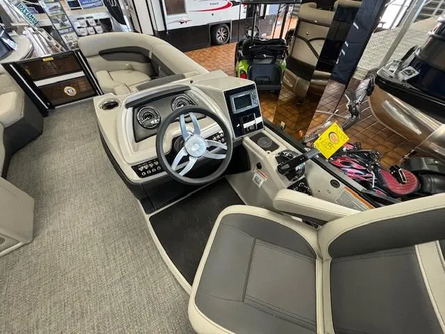 Slide: The Image of 2025 Barletta Cabrio 22 QC boat interior with modern dashboard and seating. - 11