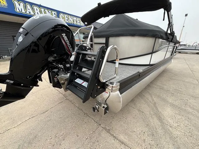 Slide: The Image of 2025 Barletta Cabrio 22 QC pontoon boat with Mercury outboard motor at marine center. - 25