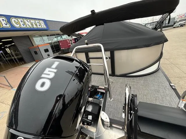 Slide: The Image of 2025 Barletta Cabrio 22 QC pontoon boat with 150 HP engine at a marine center. - 26