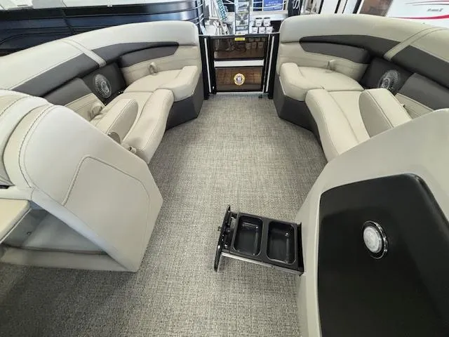 Slide: The Image of 2025 Barletta Cabrio 22 QC interior with plush seating and cup holders. - 3