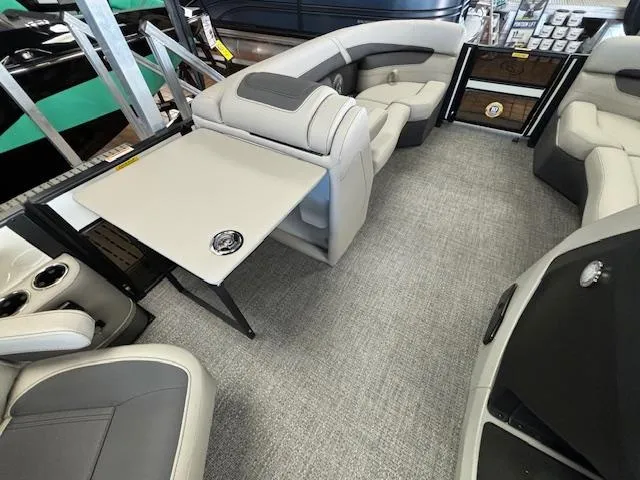 Slide: The Image of 2025 Barletta Cabrio 22 QC interior with plush seating and foldable table. - 5