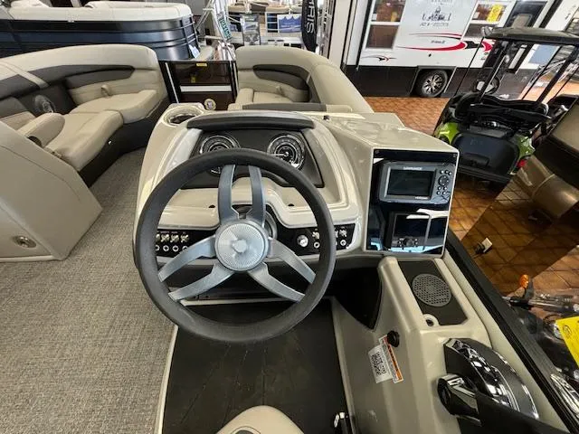 Slide: The Image of 2025 Barletta Cabrio 22 QC boat interior with steering wheel and dashboard controls. - 9