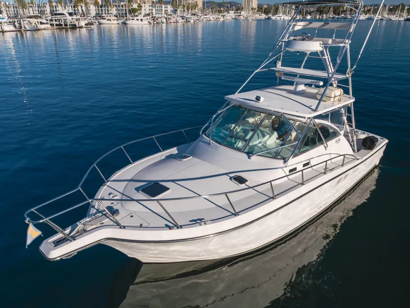 Slide: The Image of 2006 Rampage 38 Express boat on calm water, featuring sleek design and spacious deck. - 13