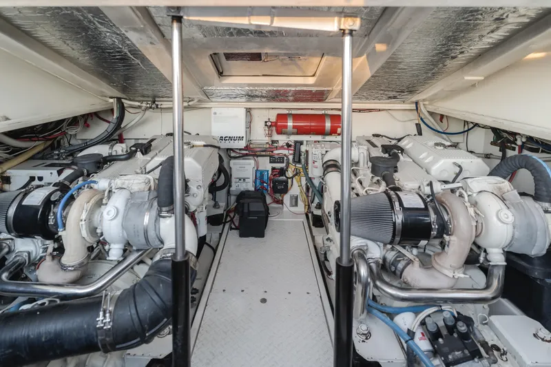 Slide: The Image of Engine room of 2006 Rampage 38 Express boat, featuring dual engines and equipment. - 17