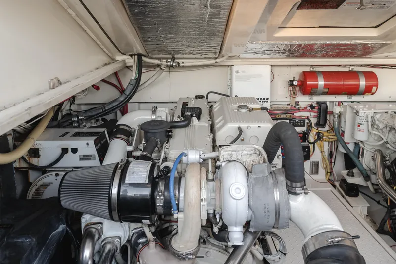 Slide: The Image of Engine room of 2006 Rampage 38 Express boat, featuring mechanical components and fire extinguisher. - 18