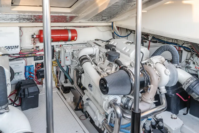 Slide: The Image of Engine room of 2006 Rampage 38 Express boat, featuring a well-maintained engine and equipment. - 19