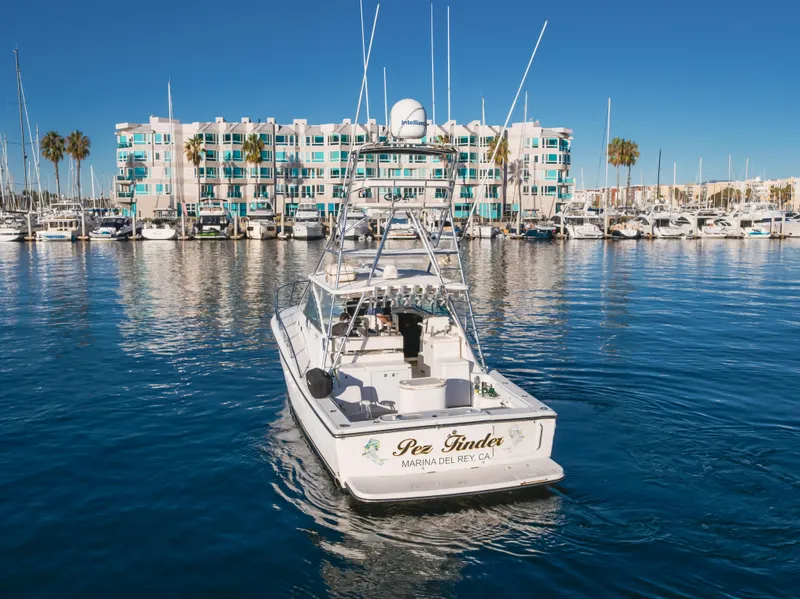 Slide: The Image of Rampage 38 Express 2006 boat in marina, clear blue sky, waterfront building backdrop. - 2