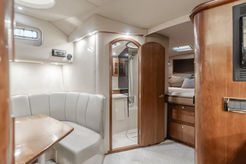 Slide: The Image of Luxurious 2006 Rampage 38 Express yacht interior with dining area and cozy sleeping quarters. - 21