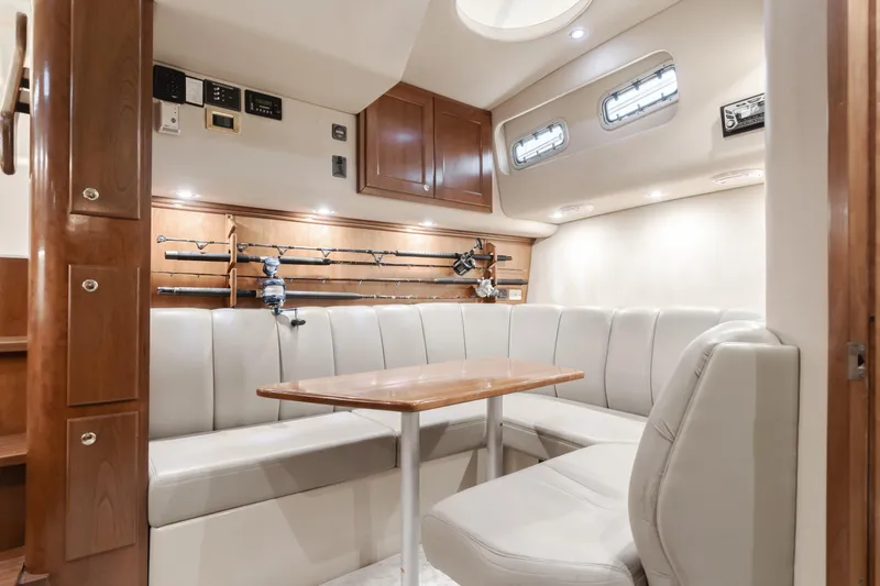 Slide: The Image of Luxurious 2006 Rampage 38 Express yacht interior with plush seating and fishing rod storage. - 22