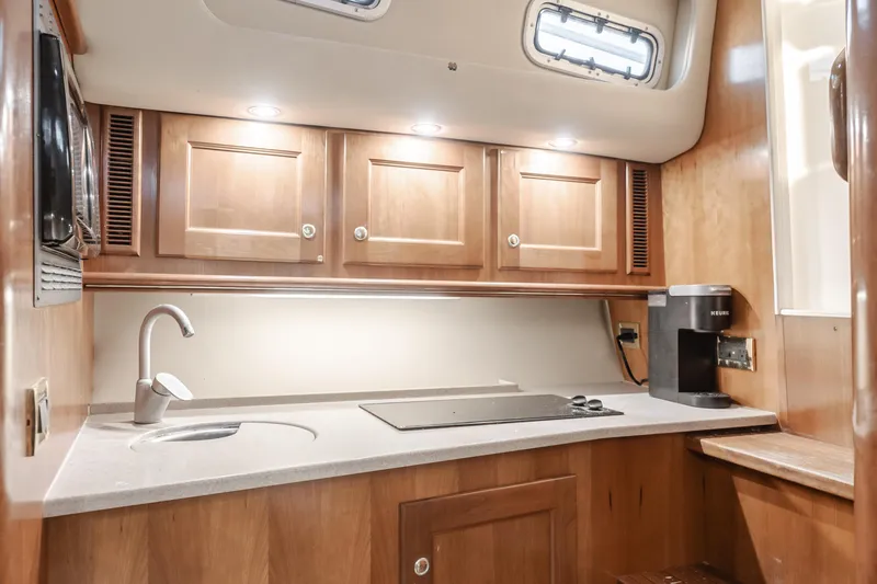 Slide: The Image of Luxurious 2006 Rampage 38 Express yacht kitchen with wooden cabinets and modern appliances. - 23