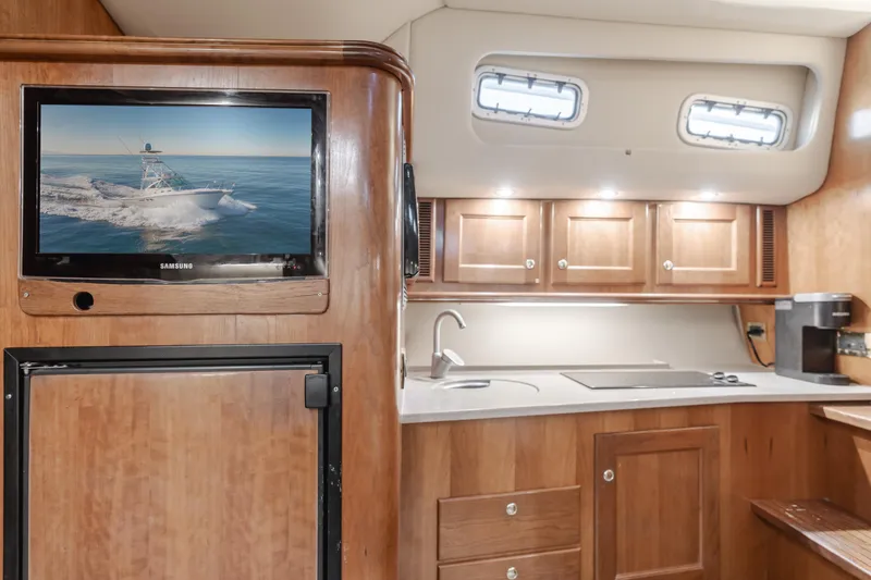 Slide: The Image of Luxurious 2006 Rampage 38 Express yacht interior with wood cabinetry and modern amenities. - 24