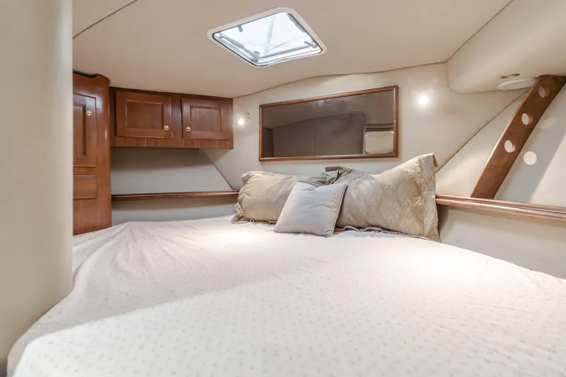 Slide: The Image of Luxurious cabin interior of 2006 Rampage 38 Express yacht with cozy bedding. - 26