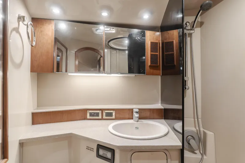 Slide: The Image of Luxurious bathroom in 2006 Rampage 38 Express yacht with modern fixtures and wood accents. - 27