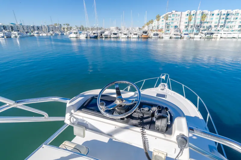 Slide: The Image of Rampage 38 Express 2006 boat helm overlooking marina with docked yachts. - 31