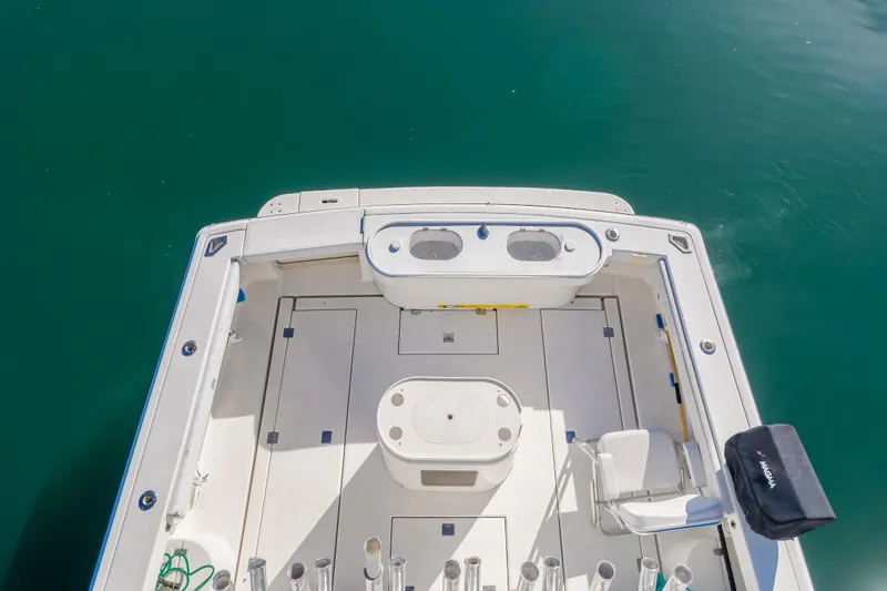 Slide: The Image of 2006 Rampage 38 Express boat deck with fishing rod holders and seating. - 32