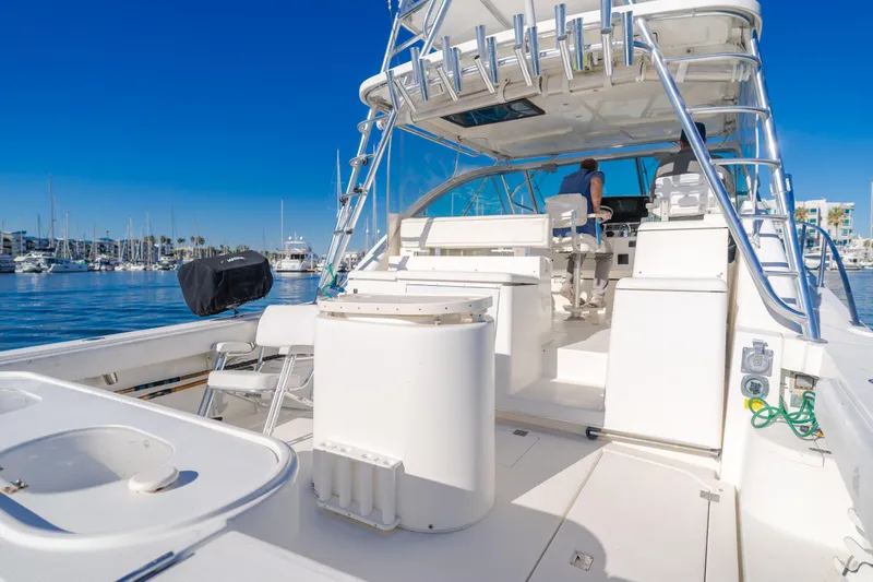 Slide: The Image of 2006 Rampage 38 Express yacht interior with marina view, featuring sleek white design and modern amenities. - 36