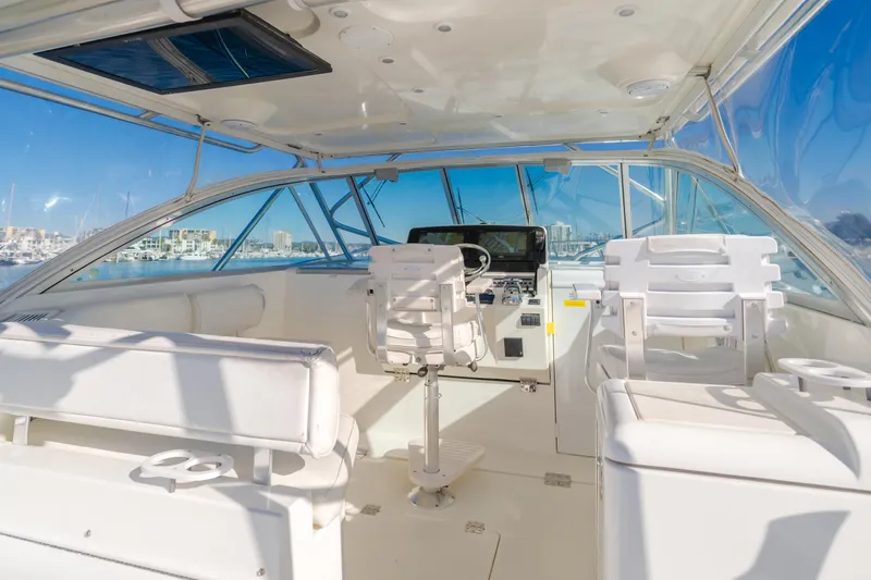 Slide: The Image of Interior of 2006 Rampage 38 Express boat with white seating and helm. - 38