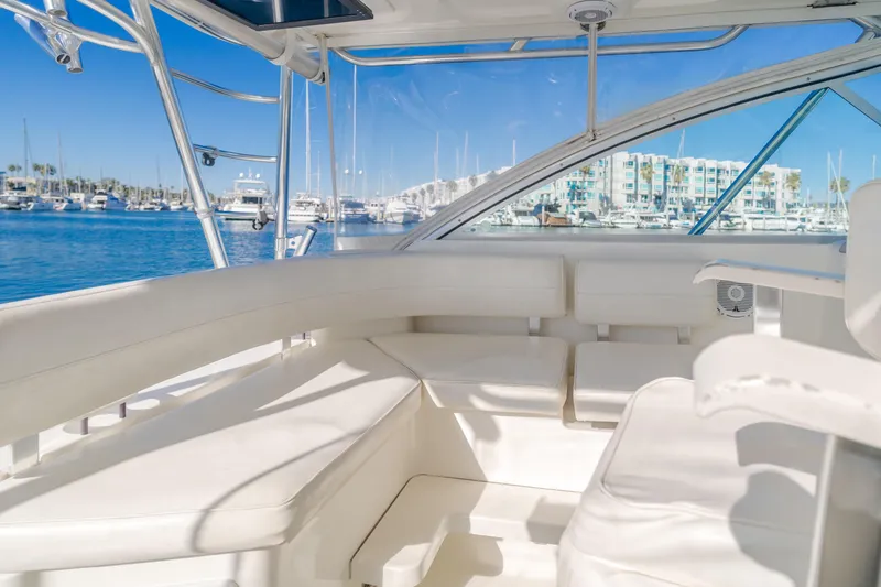 Slide: The Image of 2006 Rampage 38 Express yacht interior with white seating, marina view. - 39
