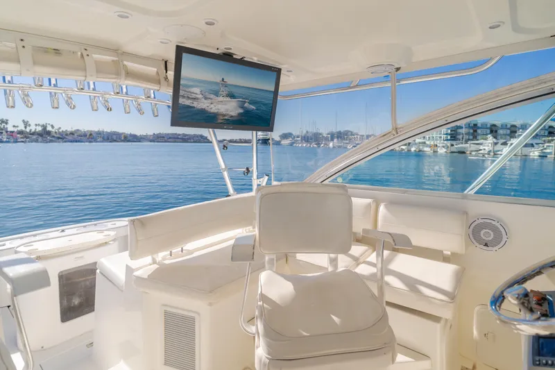 Slide: The Image of 2006 Rampage 38 Express yacht interior with helm, chair, and waterfront view. - 43