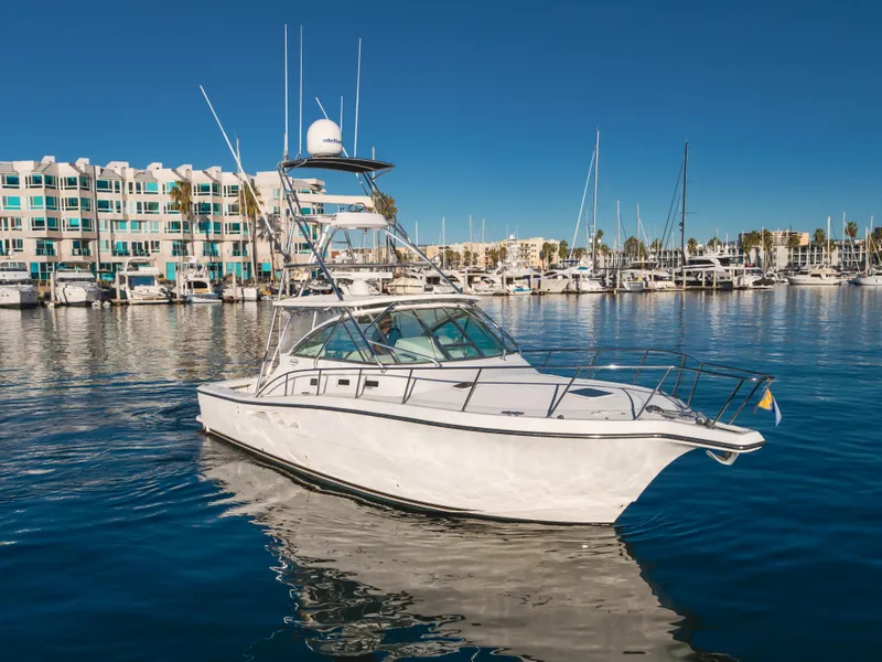 Slide: The Image of 2006 Rampage 38 Express yacht in marina, clear blue sky, waterfront buildings. - 6