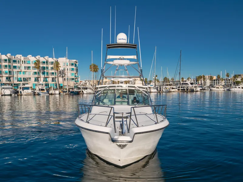 Slide: The Image of 2006 Rampage 38 Express yacht docked in a marina with clear blue skies. - 7