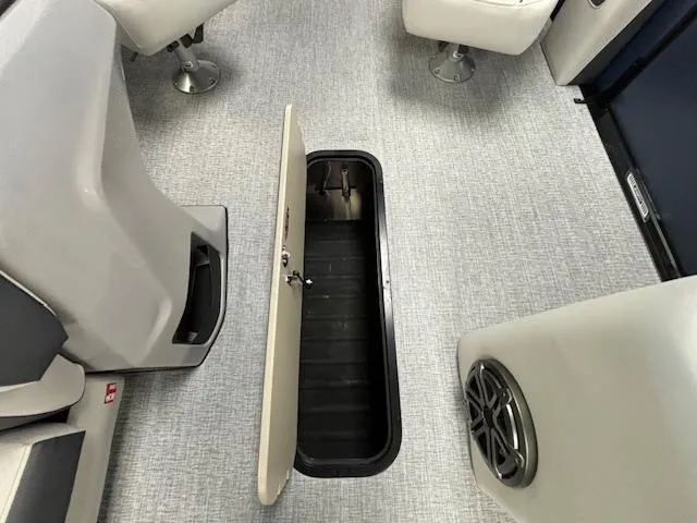 Slide: The Image of 2025 Harris SUNLINER 230 SLDH boat interior with open storage compartment. - 13
