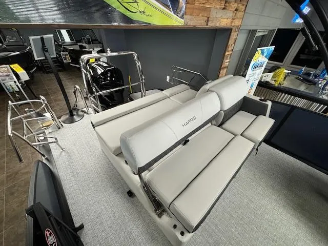 Slide: The Image of 2025 Harris SUNLINER 230 SLDH boat interior with gray seating in showroom. - 19