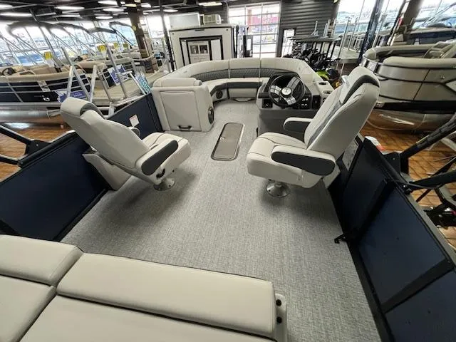Slide: The Image of 2025 Harris SUNLINER 230 SLDH pontoon boat interior with plush seating and modern helm. - 26