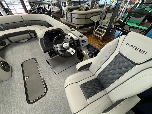Slide: The Image of 2025 Harris SUNLINER 230 SLDH boat interior with modern seating and steering console. - 28