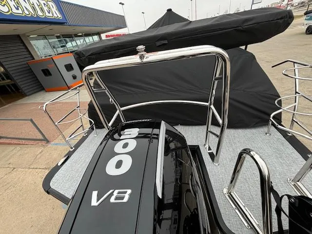 Slide: The Image of 2025 Harris SUNLINER 230 SLDH boat with 300 V8 engine, docked at a marina. - 3