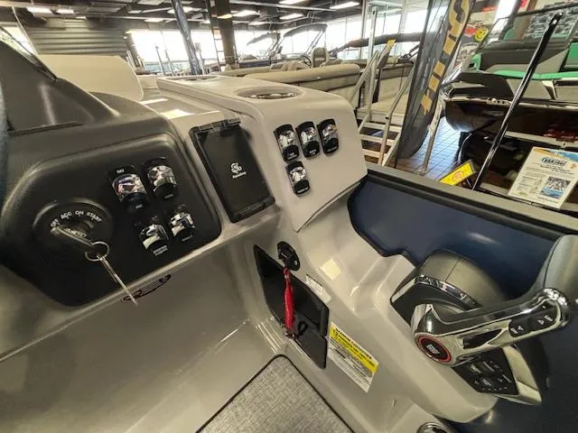 Slide: The Image of 2025 Harris SUNLINER 230 SLDH boat dashboard with controls and steering wheel. - 30