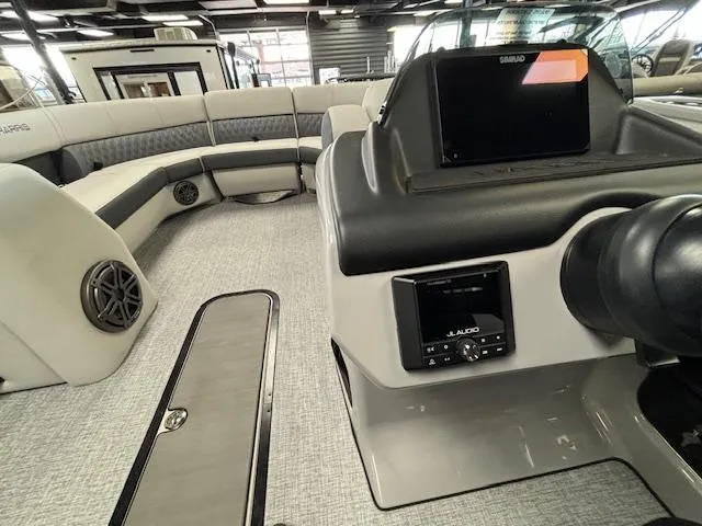 Slide: The Image of 2025 Harris SUNLINER 230 SLDH boat interior with modern seating and control panel. - 32