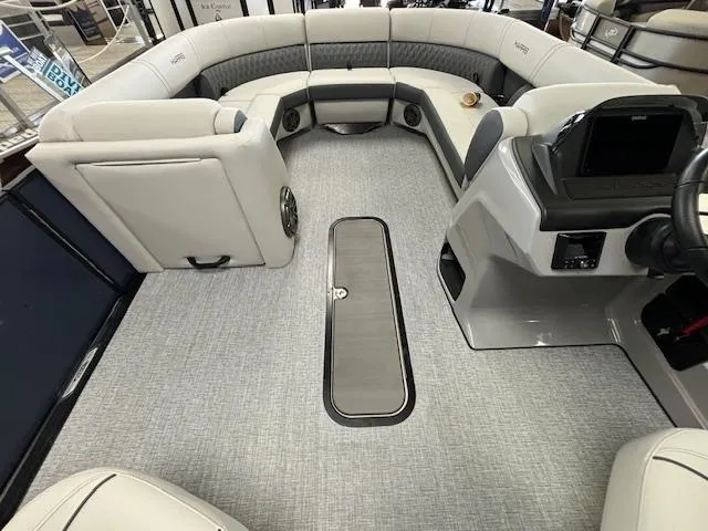 Slide: The Image of 2025 Harris SUNLINER 230 SLDH boat interior with plush seating and modern dashboard. - 33