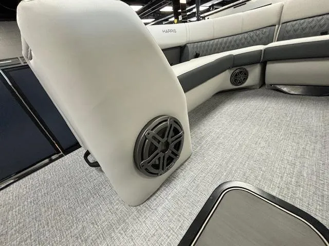 Slide: The Image of 2025 Harris SUNLINER 230 SLDH boat interior with plush seating and built-in speakers. - 35