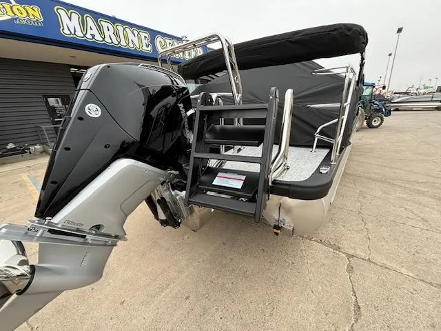 Slide: The Image of 2025 Harris SUNLINER 230 SLDH pontoon boat with outboard motor at marine dealership. - 4