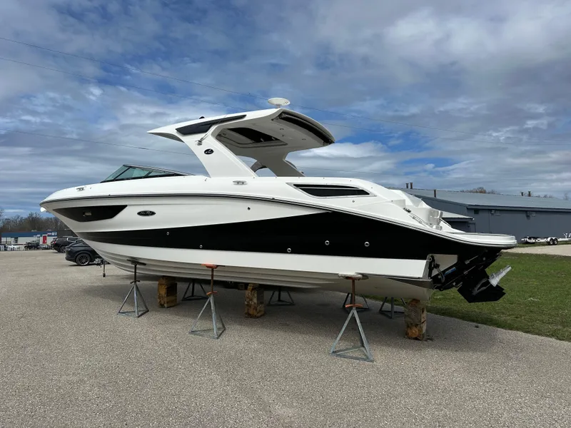 Slide: The Image of 2025 Sea Ray SLX 350 boat on stands, displayed outdoors under cloudy sky. - 1