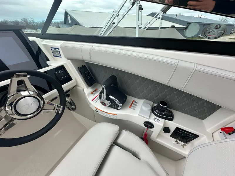 Slide: The Image of Interior view of 2025 Sea Ray SLX 350 boat cockpit with modern controls and steering wheel. - 10
