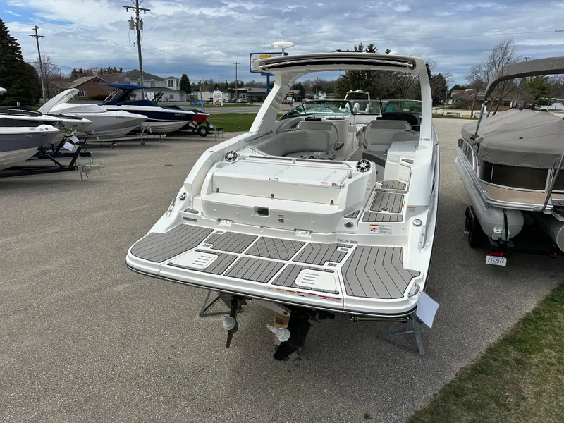 Slide: The Image of 2025 Sea Ray SLX 350 boat displayed outdoors, showcasing spacious deck and sleek design. - 2