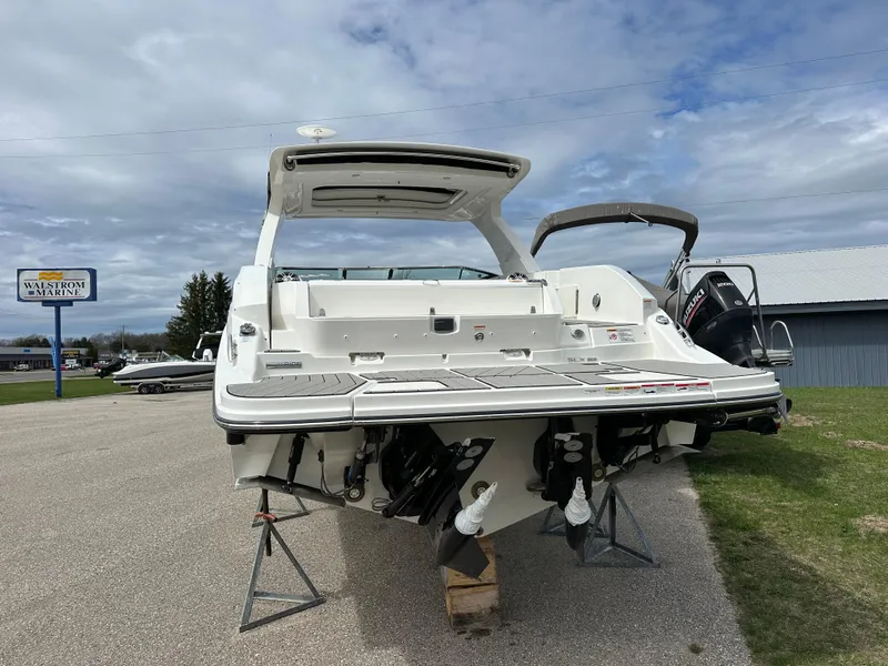 Slide: The Image of 2025 Sea Ray SLX 350 boat displayed outdoors on stands, rear view. - 3