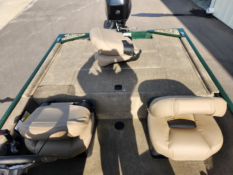 Slide: The Image of 2025 Tracker Bass Tracker Classic XL Limited boat interior with beige seats and motor. - 12