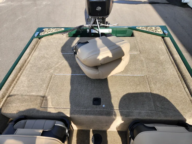 Slide: The Image of 2025 Tracker Bass Tracker Classic XL Limited boat interior with beige seating and carpeted deck. - 13