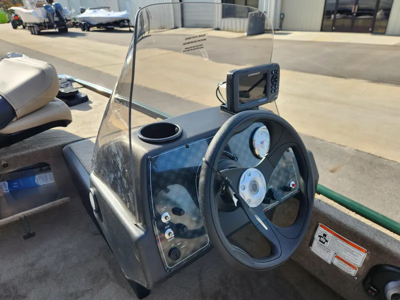 Slide: The Image of 2025 Tracker Bass Tracker Classic XL Limited boat dashboard with steering wheel and gauges. - 17