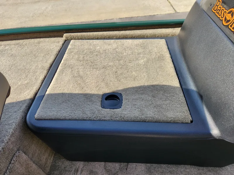 Slide: The Image of 2025 Tracker Bass Tracker Classic XL Limited boat storage compartment with carpeted lid. - 19