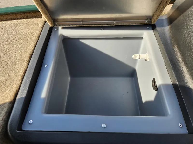 Slide: The Image of 2025 Tracker Bass Tracker Classic XL Limited livewell compartment, open and empty. - 20