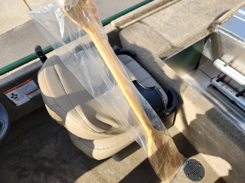 Slide: The Image of 2025 Tracker Bass Tracker Classic XL Limited boat interior with seat and wooden paddle. - 24