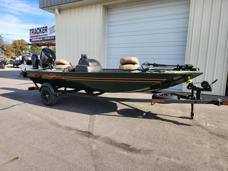 Slide: The Image of 2025 Tracker Bass Tracker Classic XL Limited boat on trailer outside dealership. - 3