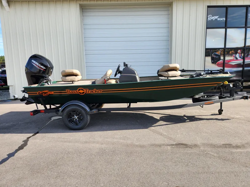 Slide: The Image of 2025 Tracker Bass Tracker Classic XL Limited boat parked outside a garage. - 4
